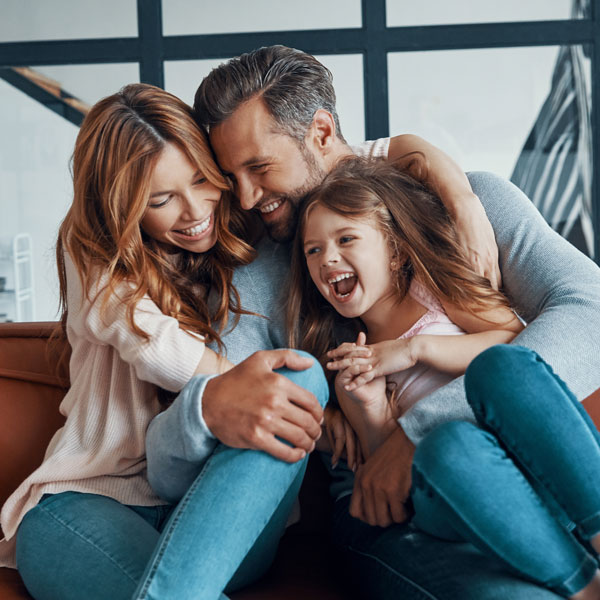young family laughing in living room