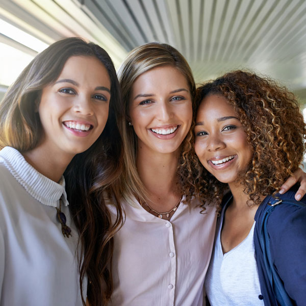 three friends smiling for photo